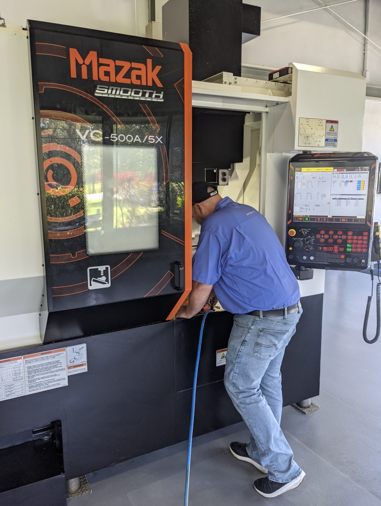 Application Engineer working on a Mazak CNC machine